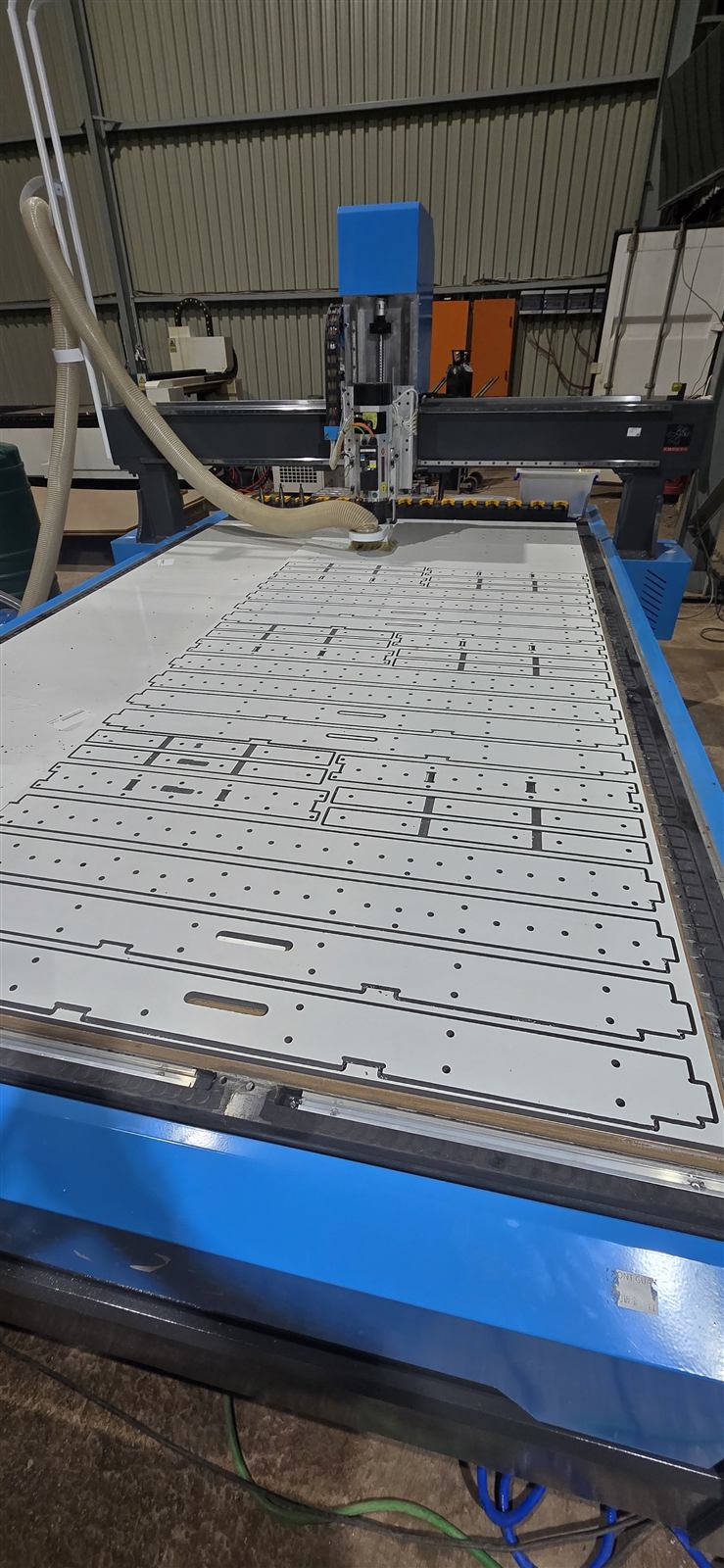 CNC router bed with EZForms panel parts nested and cut