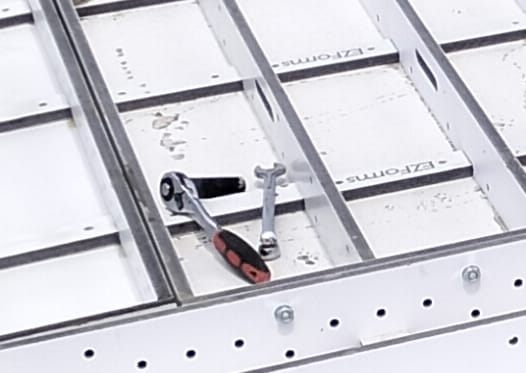 A ratchet and a spanner resting on bolted EZForms panels